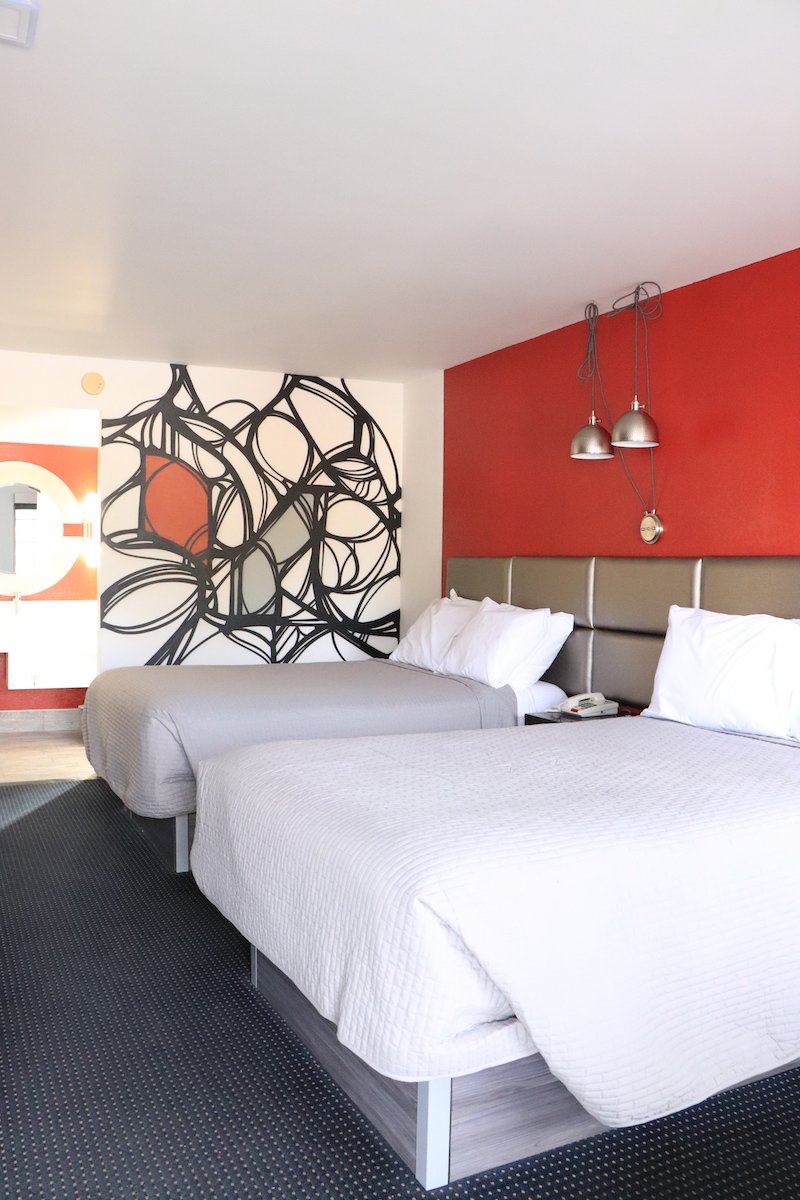 2 Double Beds — red accent wall full room view