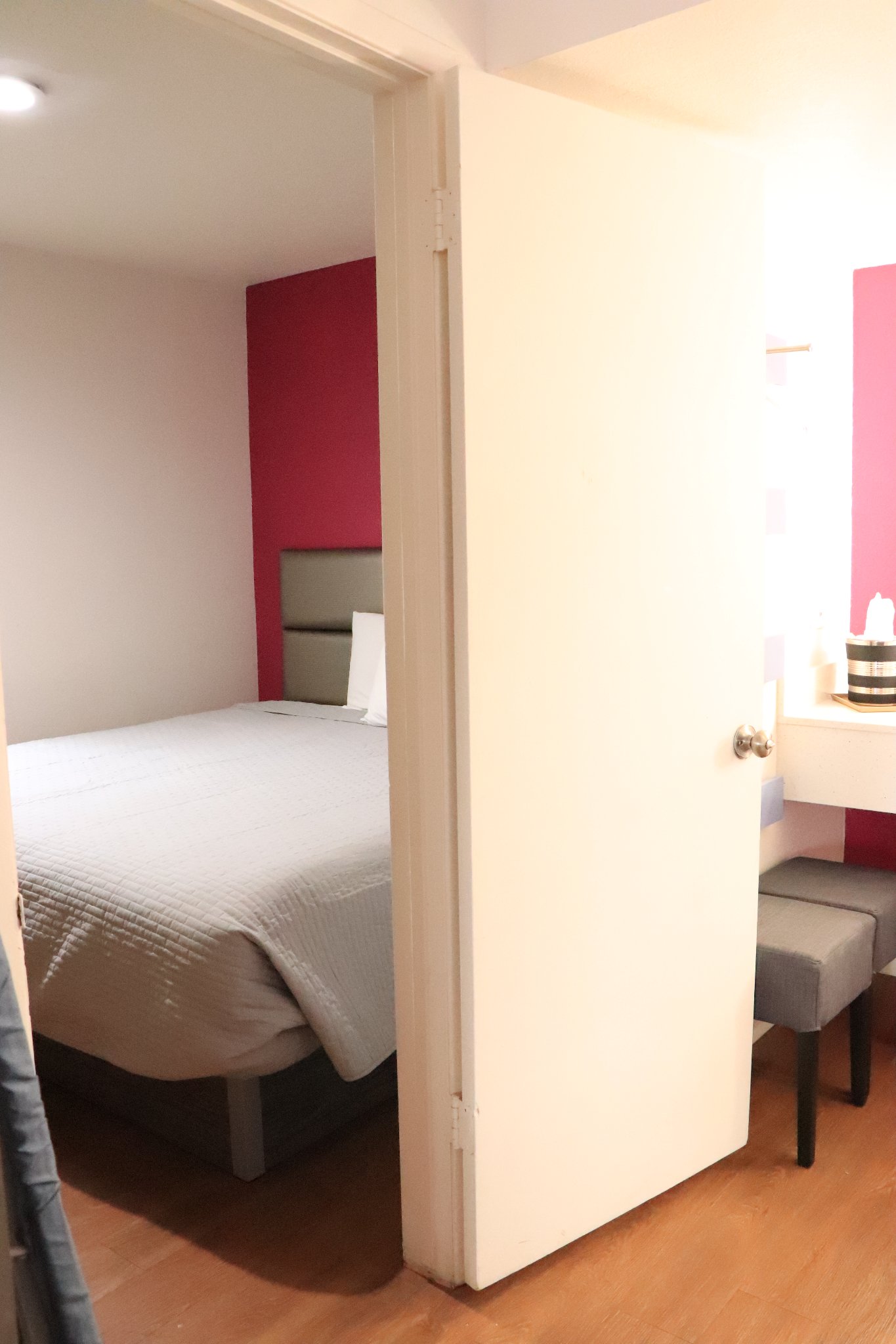 3 Bed Family Room — doorway view into bedroom with red accent wall
