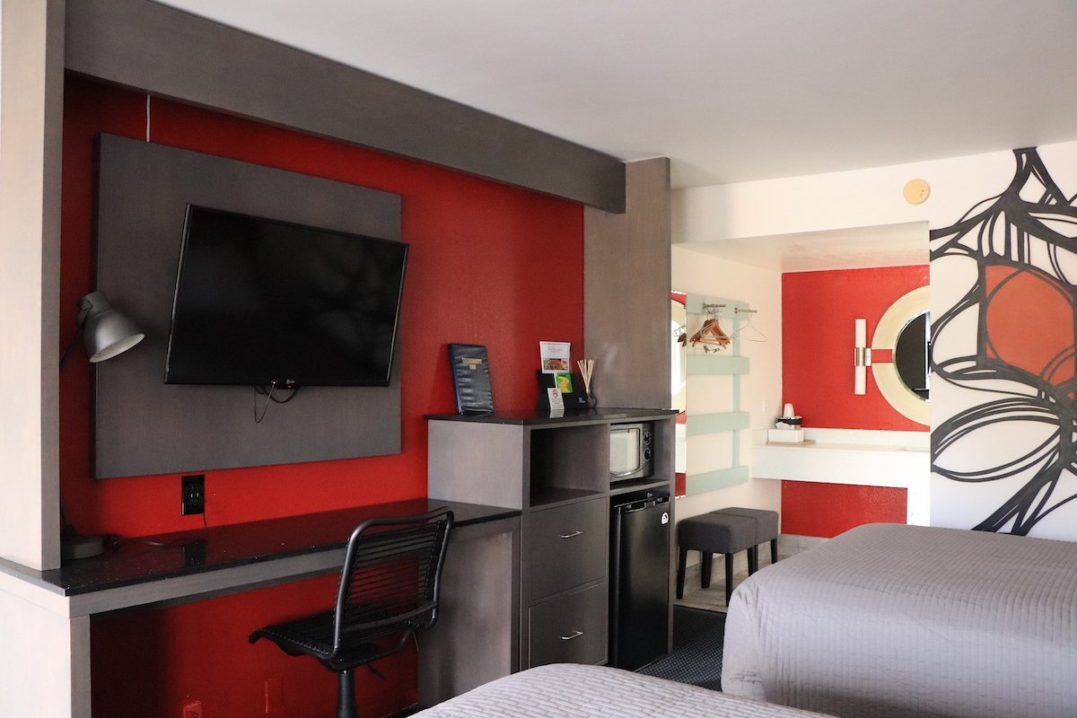 2 Double Beds — TV, desk, microwave and mini-fridge workspace
